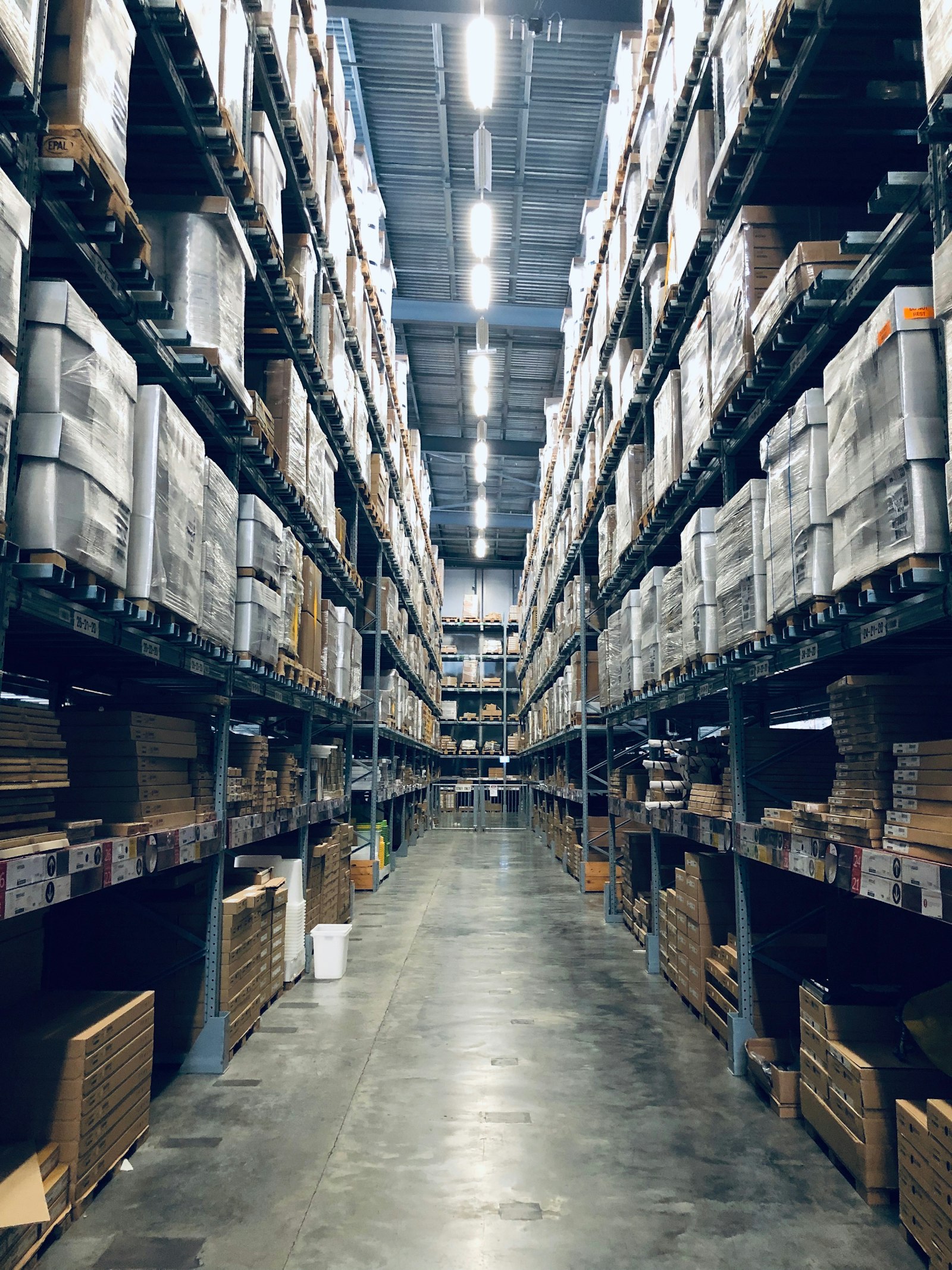 Palletised goods stacked inside a high-bay distribution warehouse